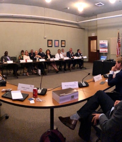 Board Meeting showing member sitting around the table