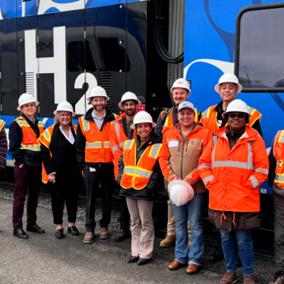 group photo of SBCTA and NCTD staff in front of ZEMU train.